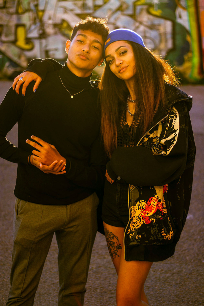 Teen boy and girl standing together hugging