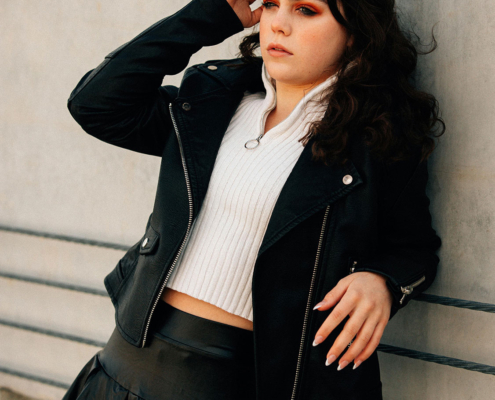 pretty teen girl standing against wall