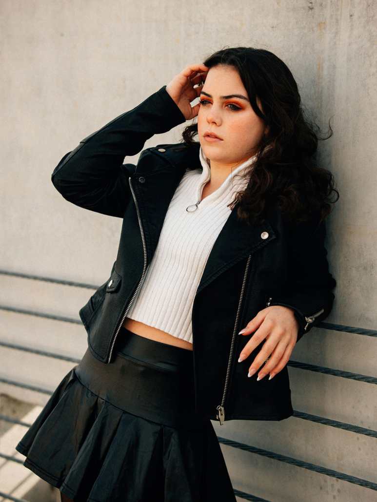 pretty teen girl standing against wall