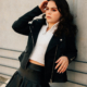 pretty teen girl standing against wall