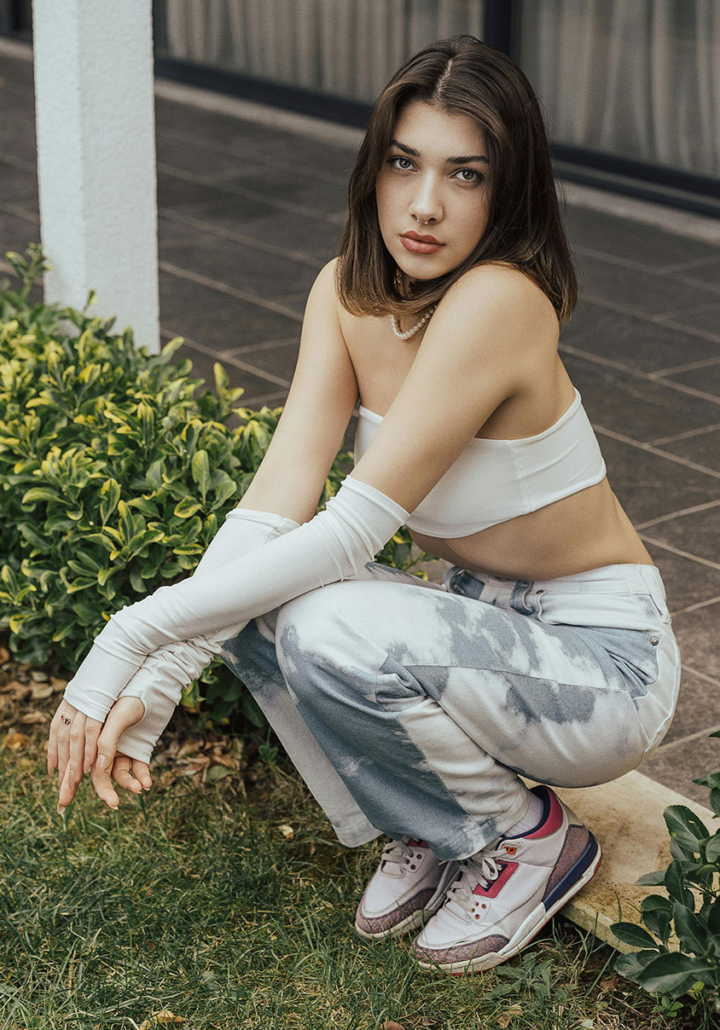 Teen girl kneeling outside