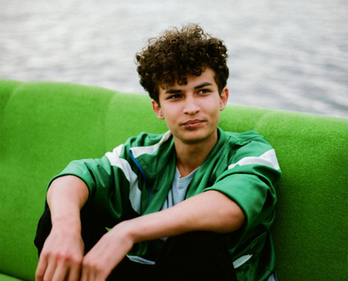 Teen boy sitting on sofa