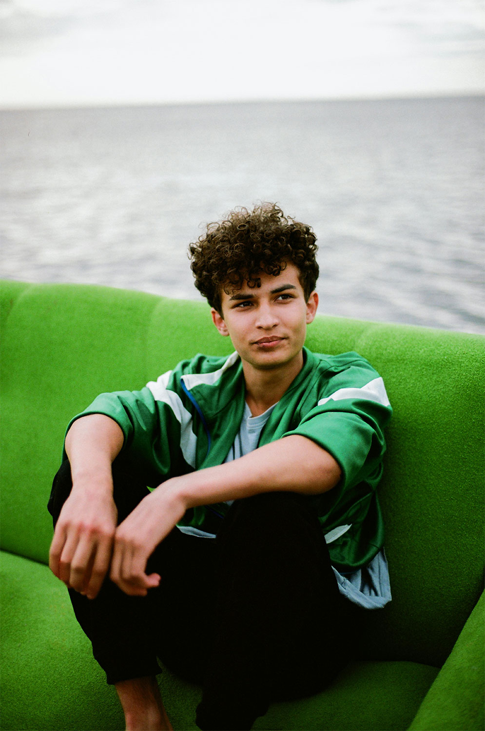 Teen boy sitting on sofa