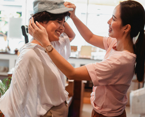 teen girls in a store trying on a hat