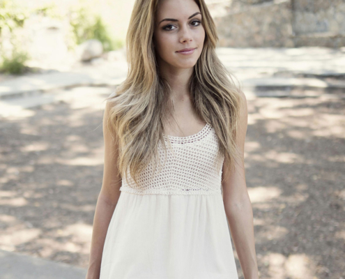 pretty young woman sitting outside
