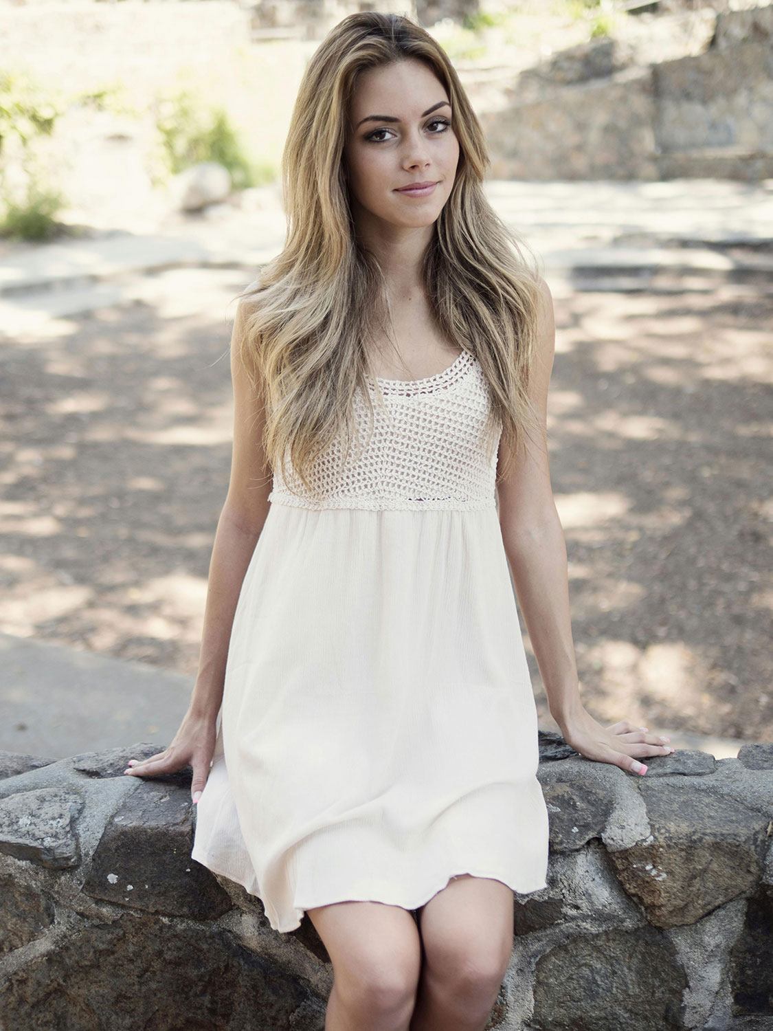 pretty young woman sitting outside