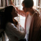 teen boy and girl in library looking at each other