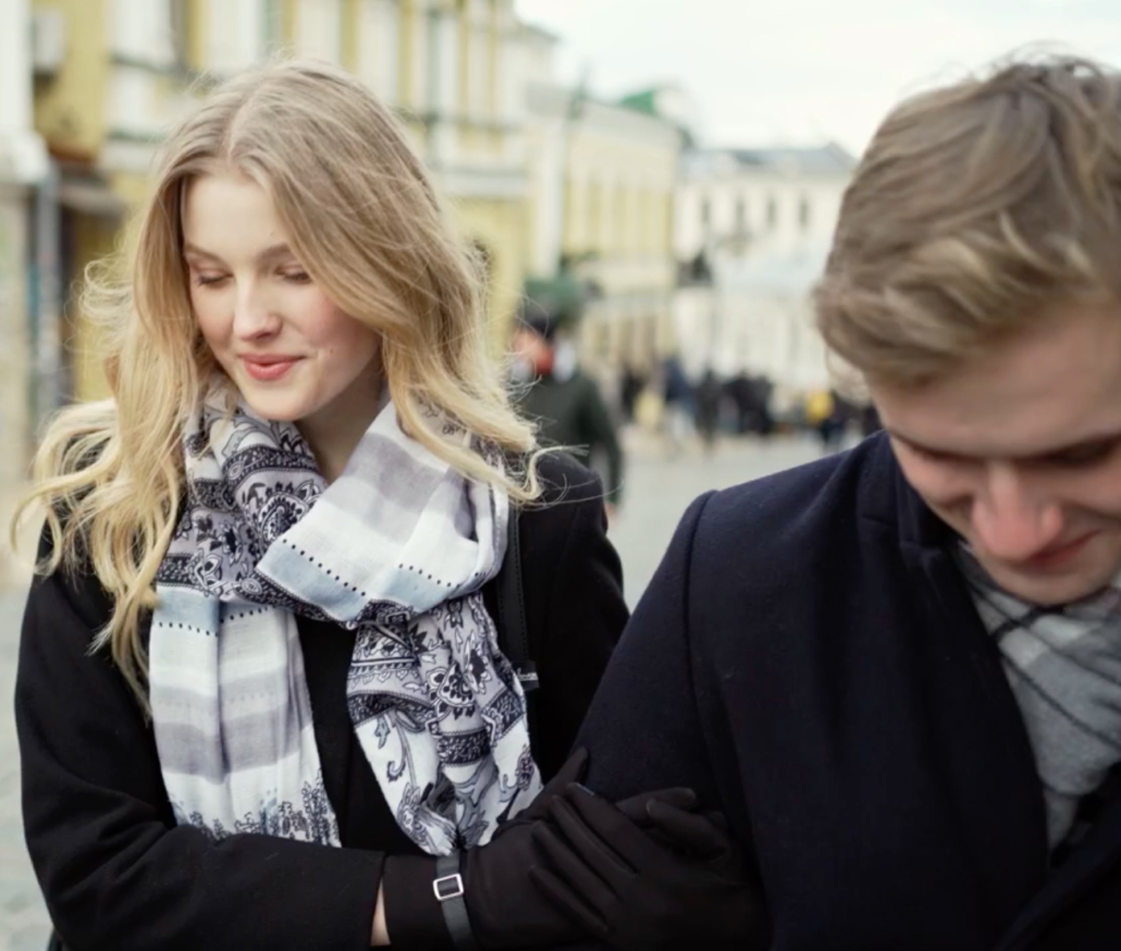 young man and women walking holding hands