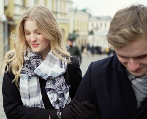 young man and women walking holding hands